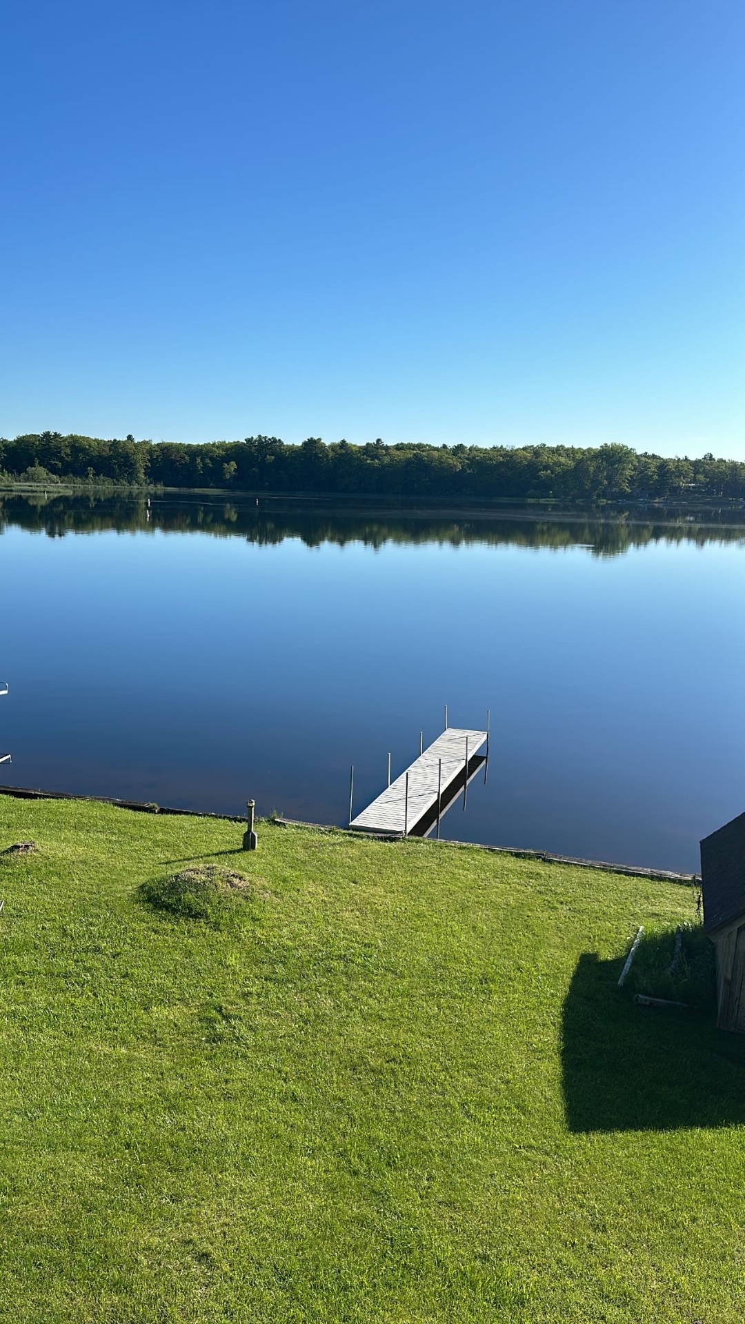 Private dock and calm water at Oscoda Lake House on Van Etten Lake